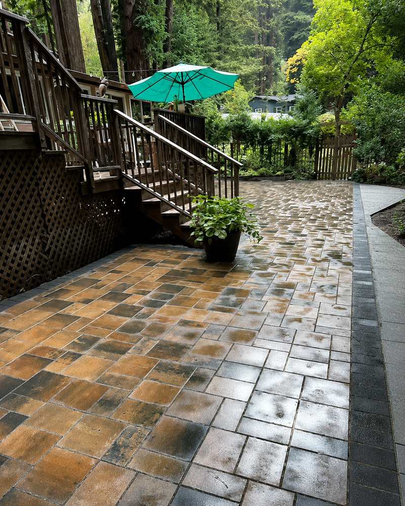 Wood deck stairs connecting to a newly installed paver patio