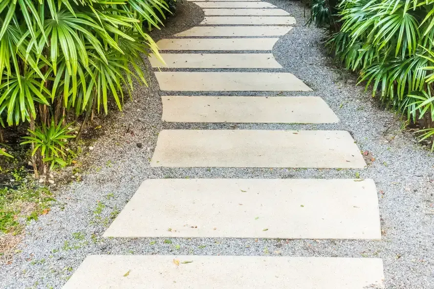 Stepping-stone path through gravel and tropical plants